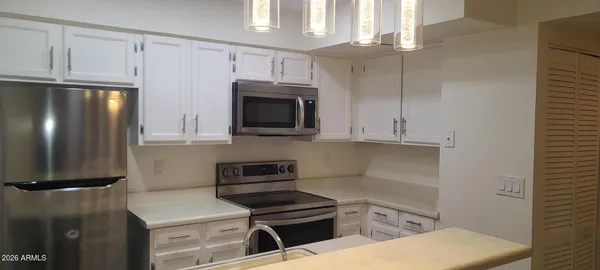 a kitchen with a refrigerator stove and microwave