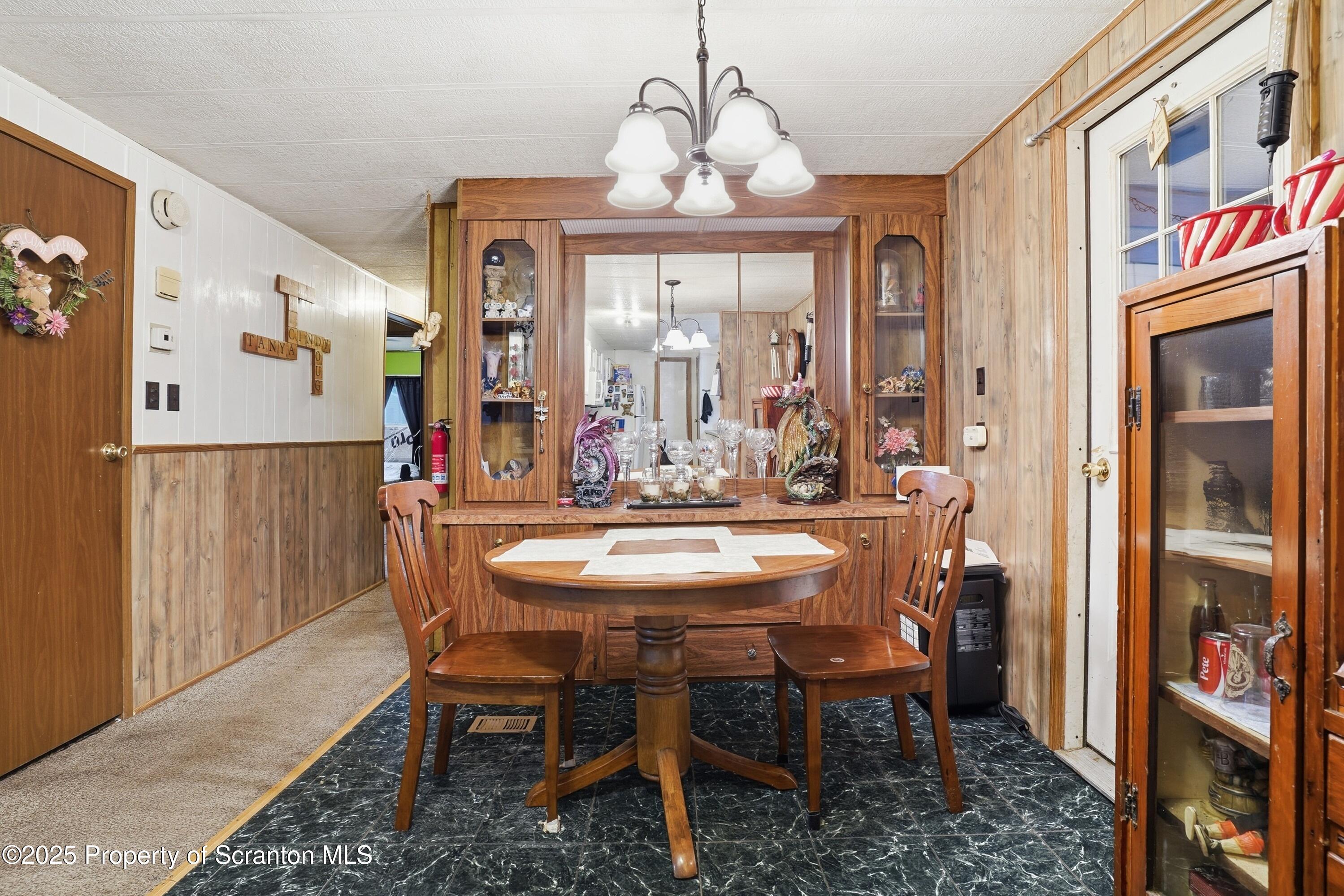 4794 Highway 706 Wyalusing, PA 18853 - Photo 13 of 40 a view of a dining room with furniture and a chandelier