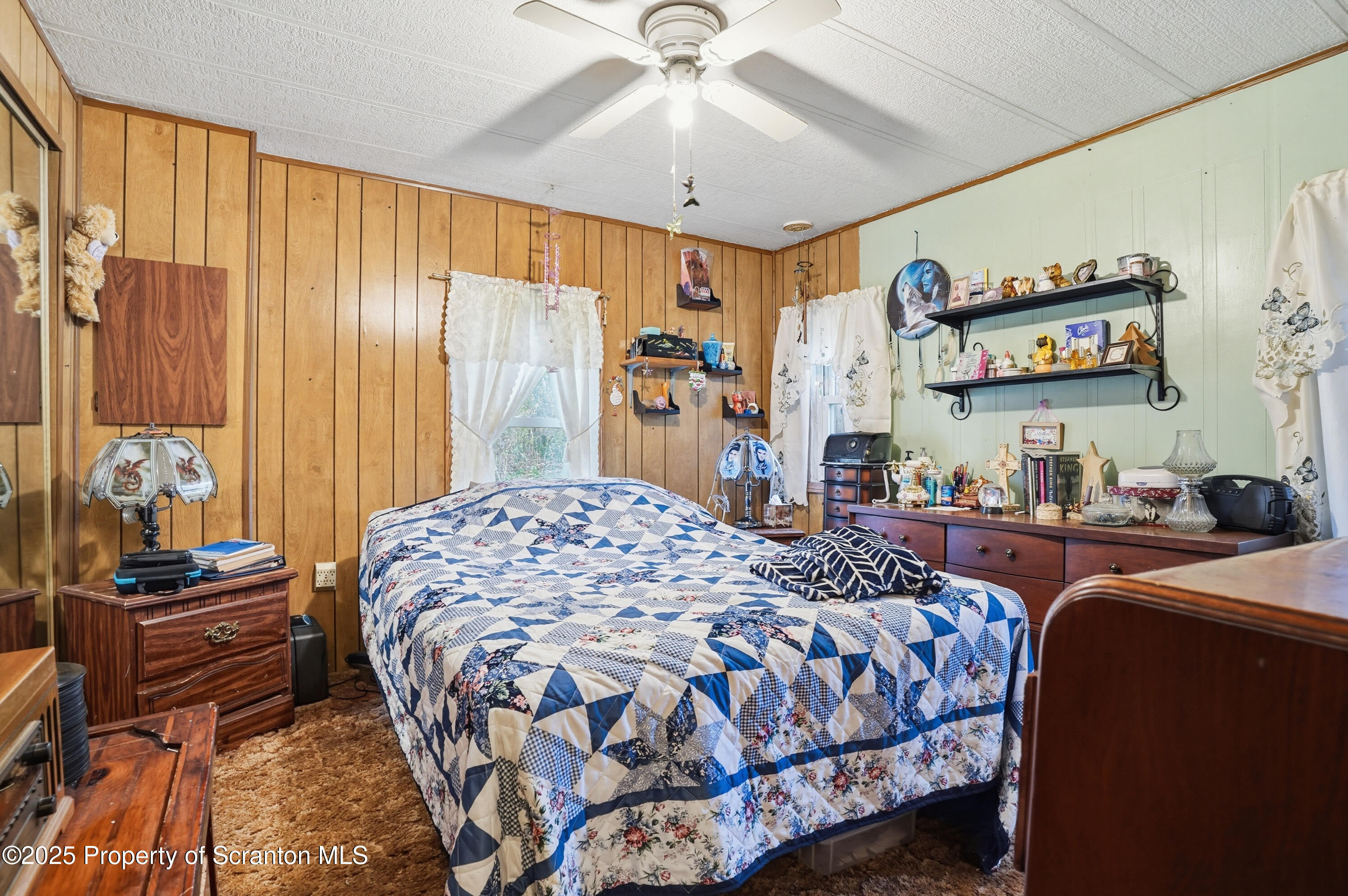 4794 Highway 706 Wyalusing, PA 18853 - Photo 18 of 40 a bedroom with a bed and a chandelier