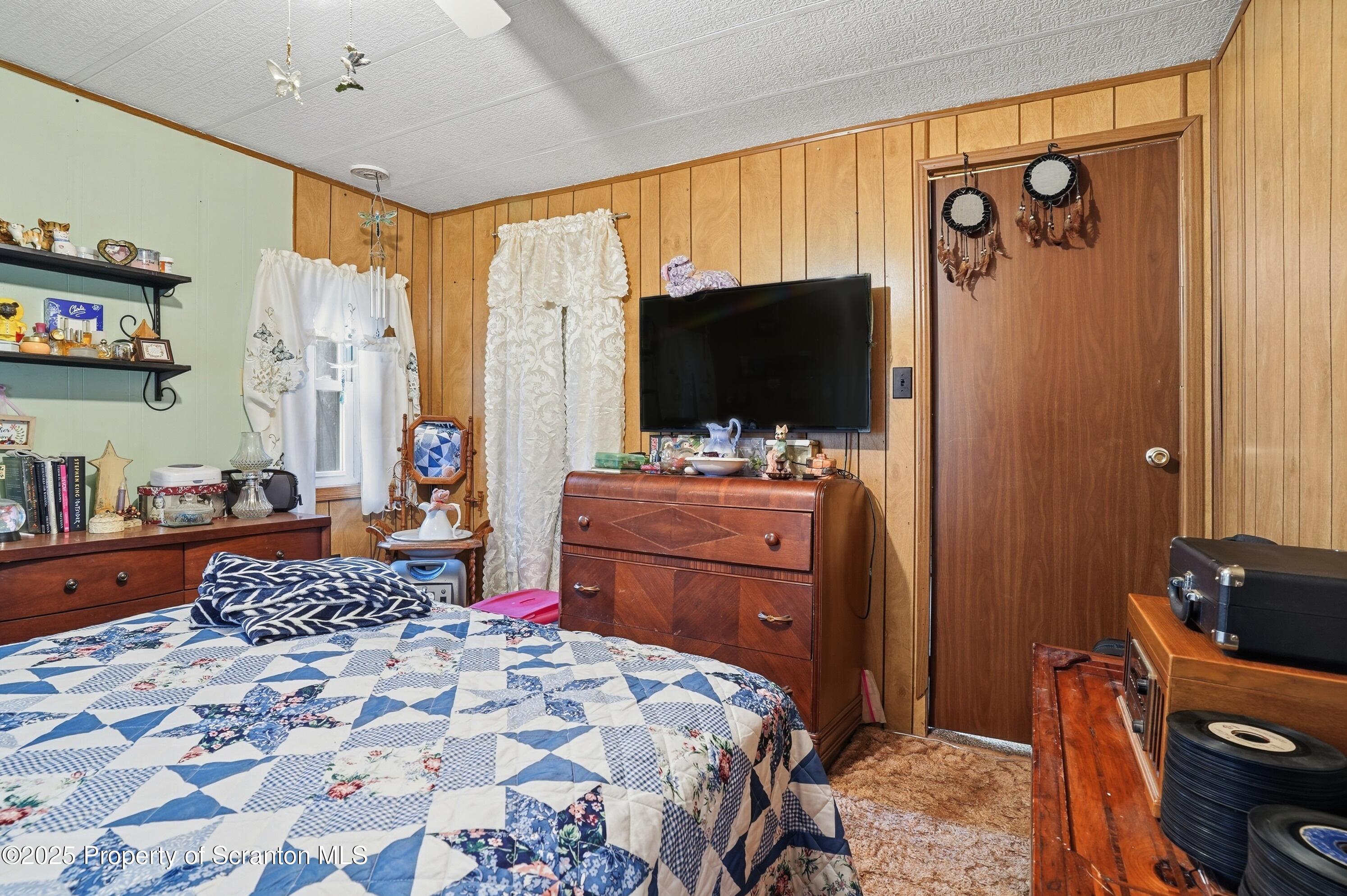 4794 Highway 706 Wyalusing, PA 18853 - Photo 19 of 40 a bedroom with a bed and flat screen tv