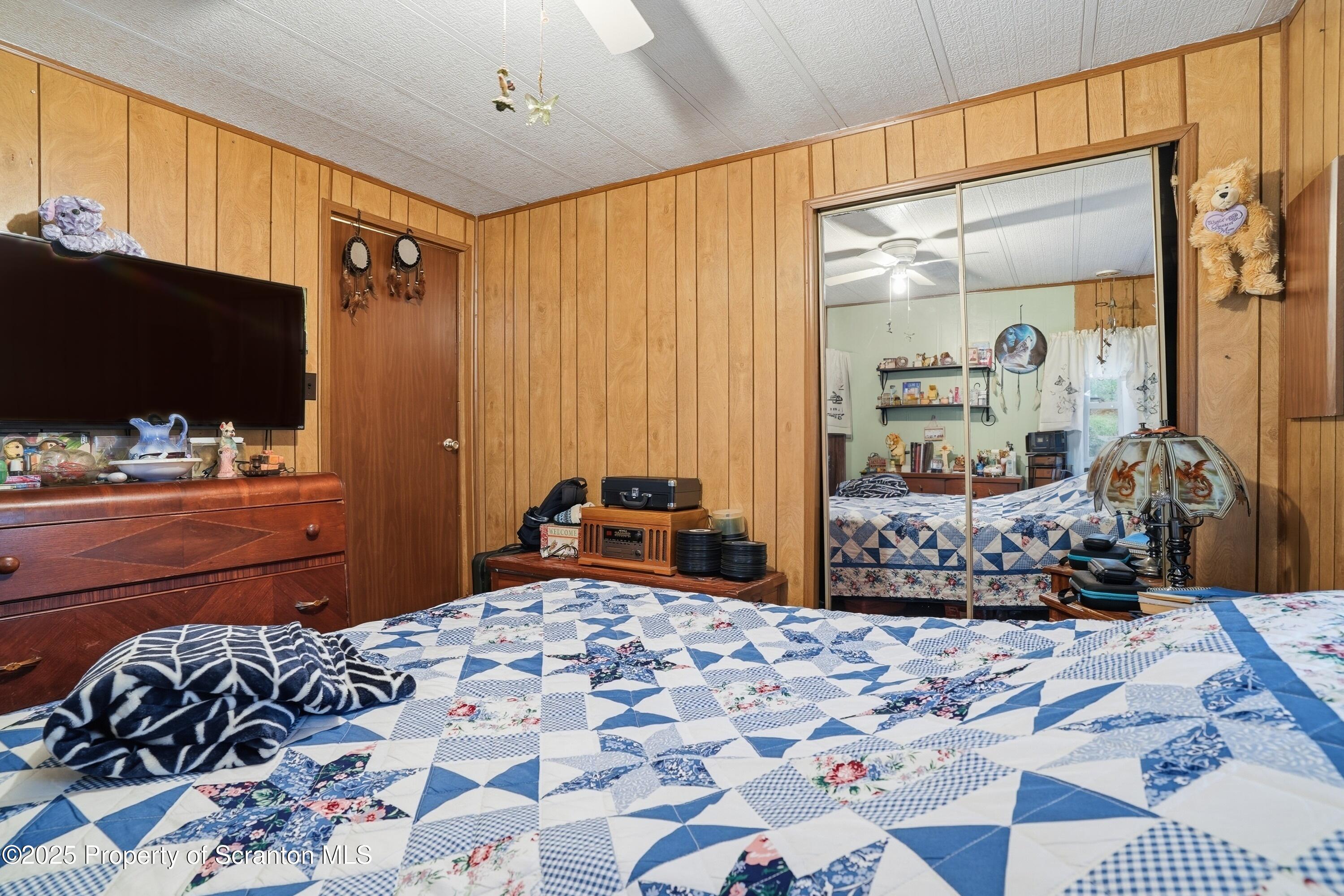 4794 Highway 706 Wyalusing, PA 18853 - Photo 20 of 40 a bedroom with a bed and flat screen tv