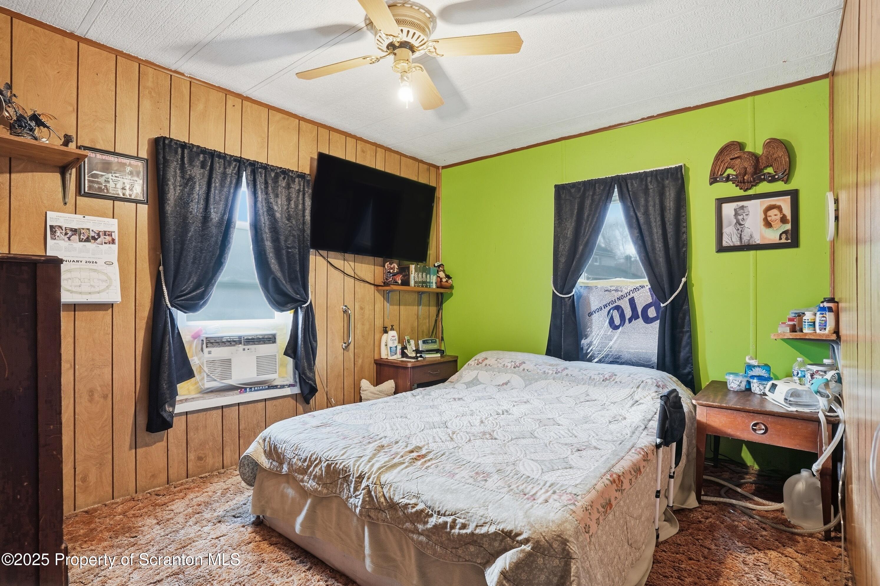 4794 Highway 706 Wyalusing, PA 18853 - Photo 21 of 40 a bedroom with a bed dresser and a flat tv screen