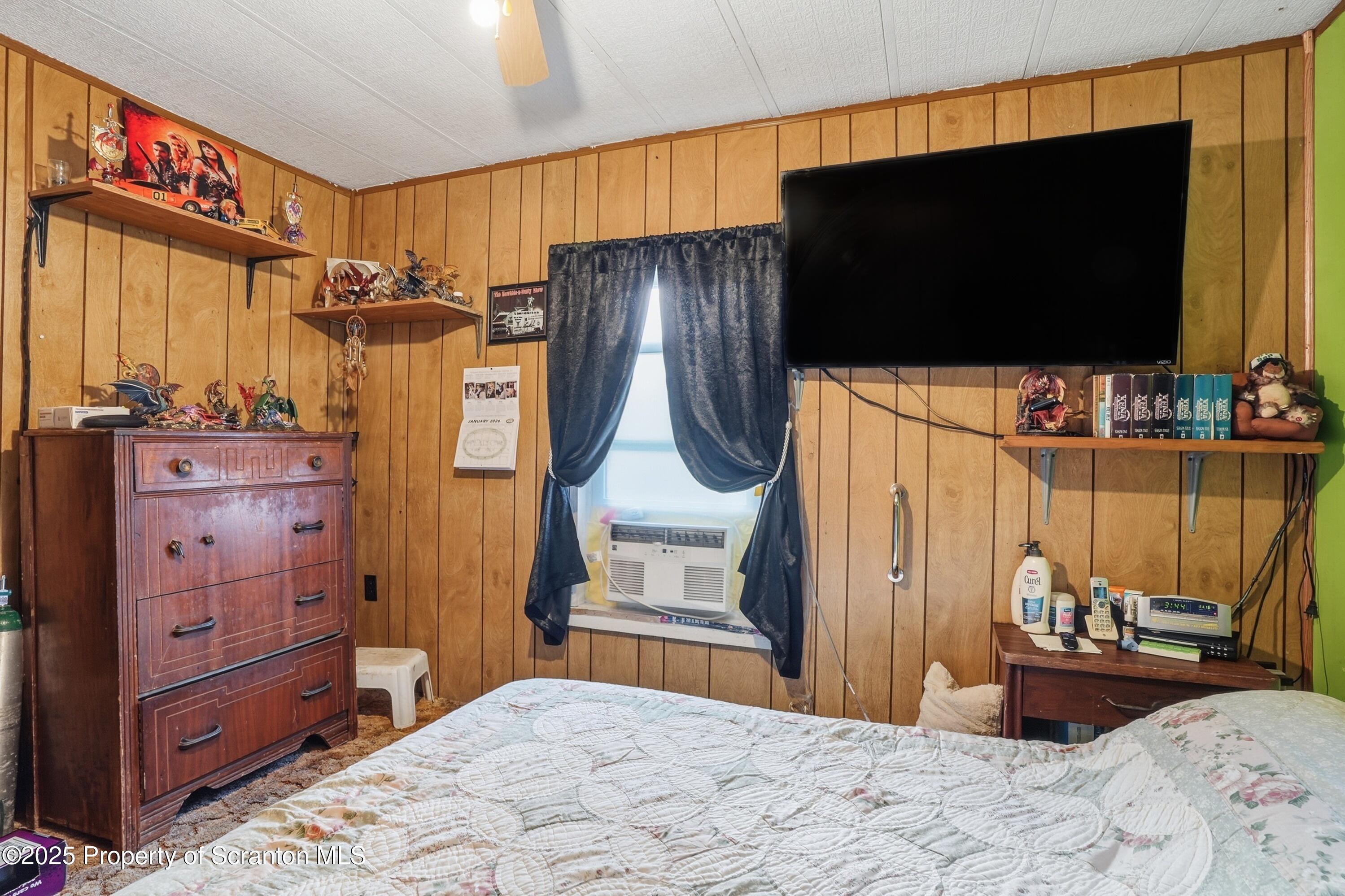 4794 Highway 706 Wyalusing, PA 18853 - Photo 22 of 40 a bedroom with a bed and a flat screen tv