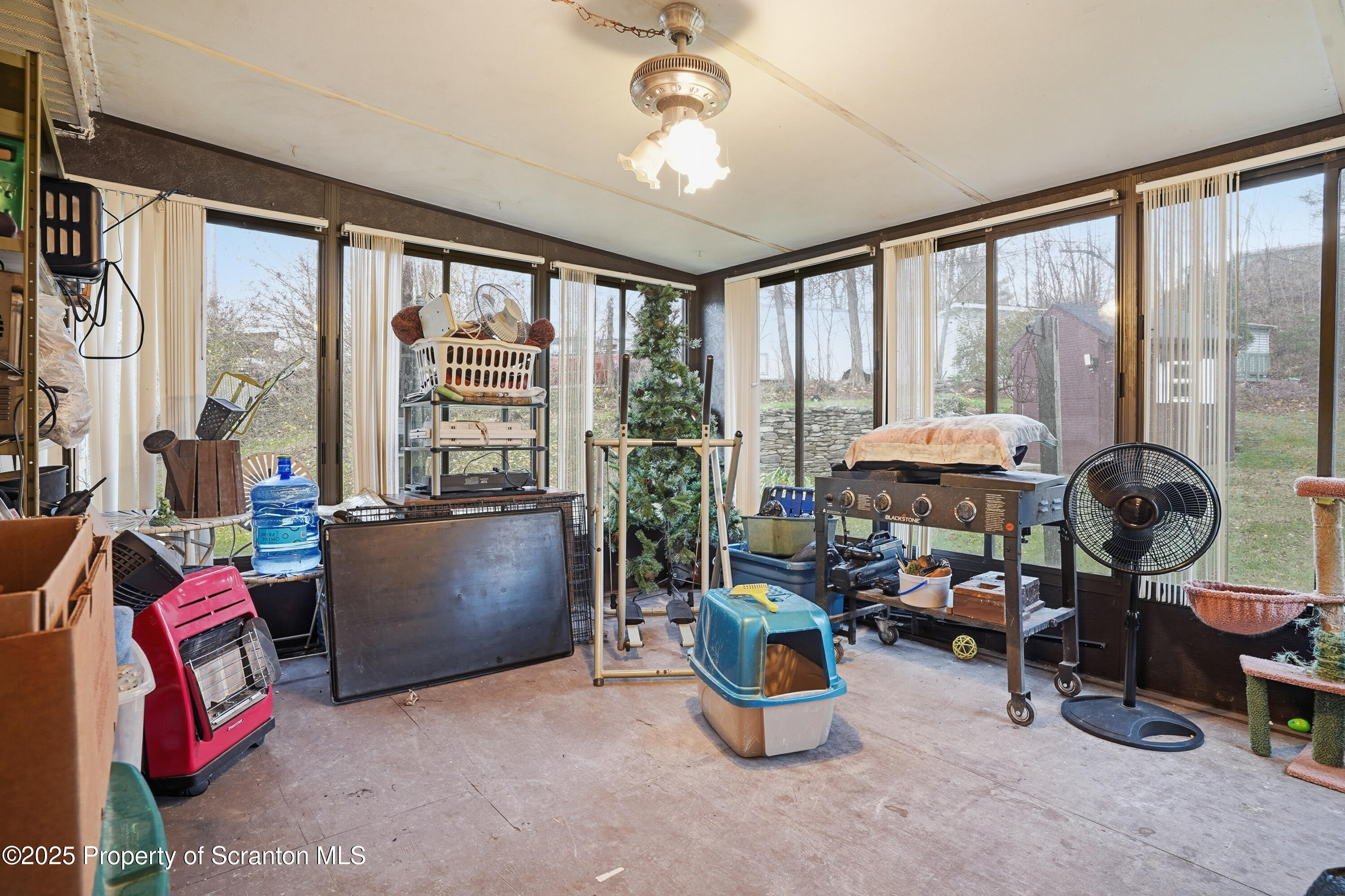 4794 Highway 706 Wyalusing, PA 18853 - Photo 28 of 40 a living room filled with furniture and a floor to ceiling window