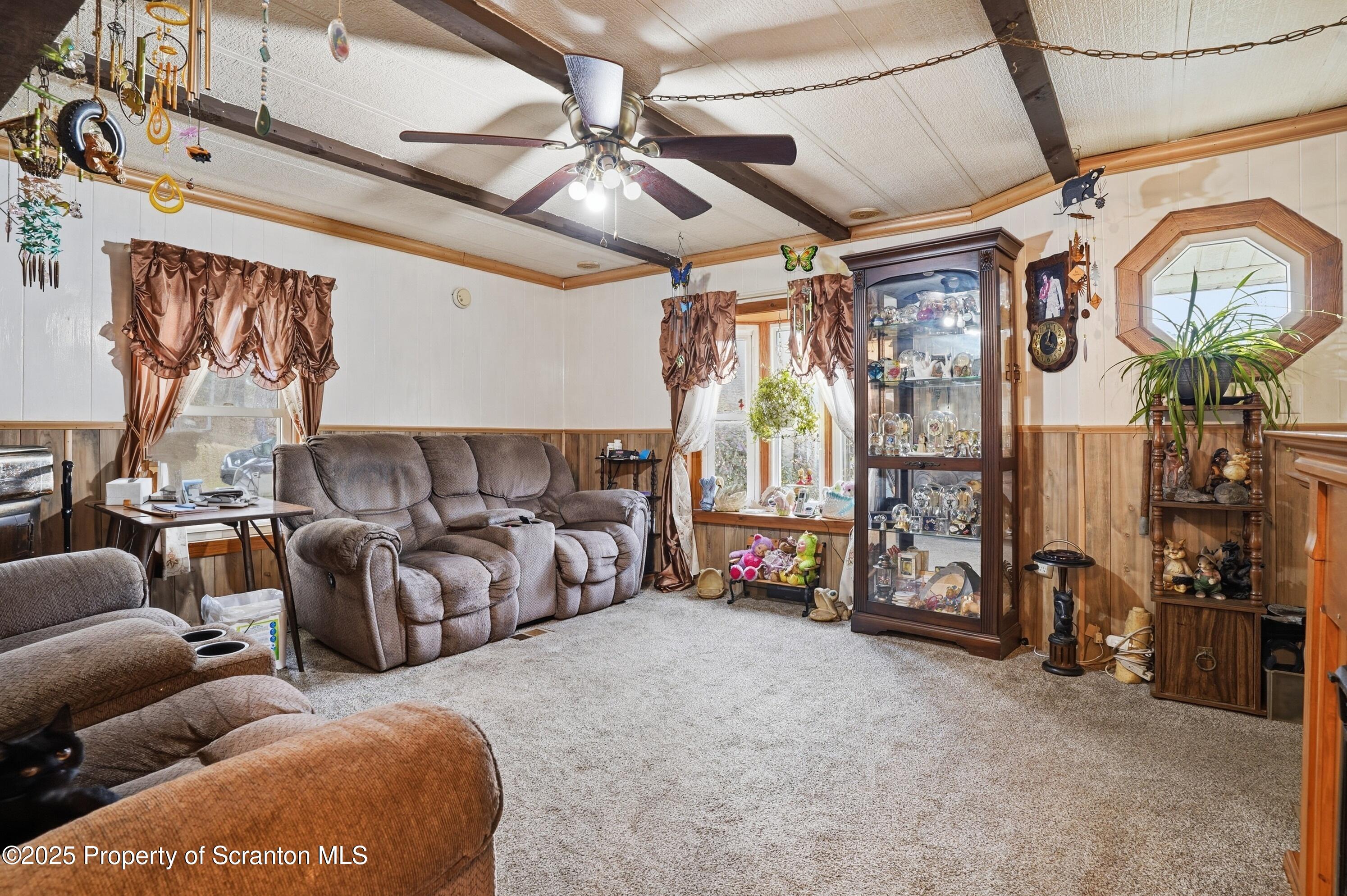 4794 Highway 706 Wyalusing, PA 18853 - Photo 6 of 40 a living room with furniture a flat screen tv and a large window