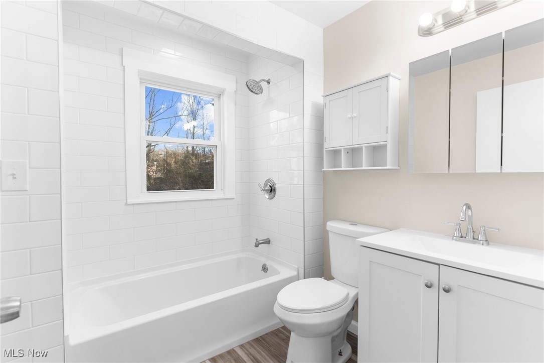 3441 Bell Wick Road Hubbard, OH 44425 - Photo 10 of 22 Full bathroom featuring hardwood / wood-style floors, vanity, toilet, and tiled shower / bath