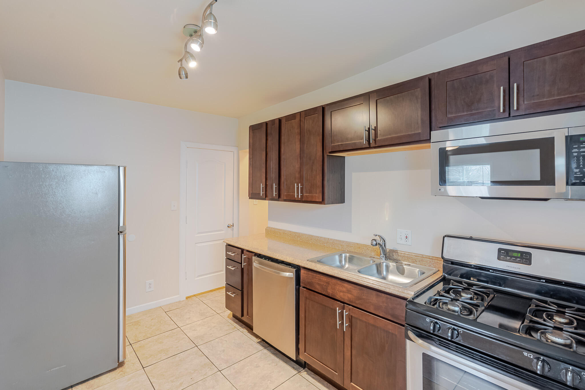 555 South Locust Street, Unit 2 Valparaiso, IN 46383 - Photo 3 of 8 a kitchen with stainless steel appliances granite countertop a stove and a microwave