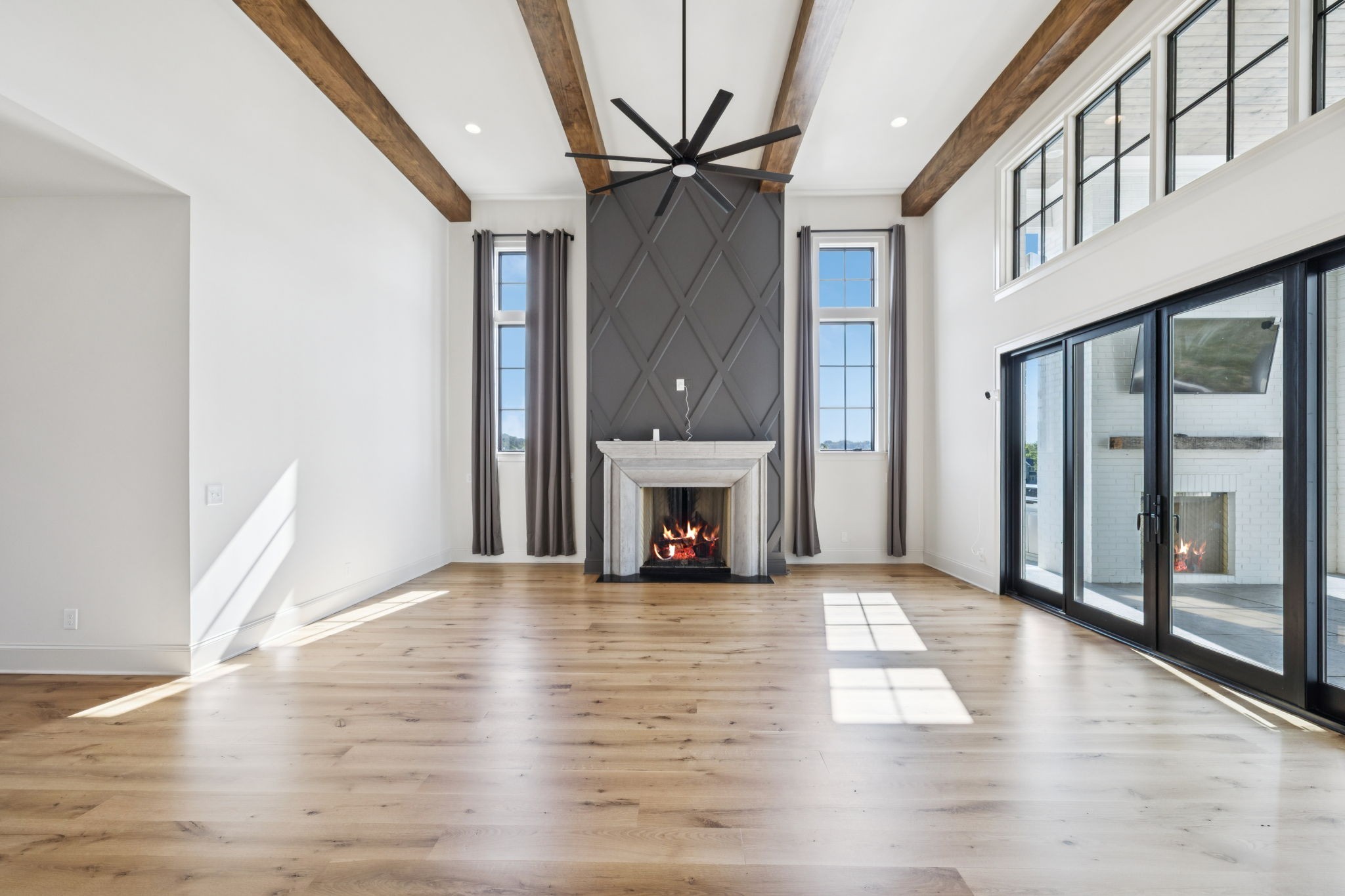 2245 Skinner Road Arrington, TN 37014 - Photo 24 of 98 a view of a livingroom with wooden floor a fireplace and window