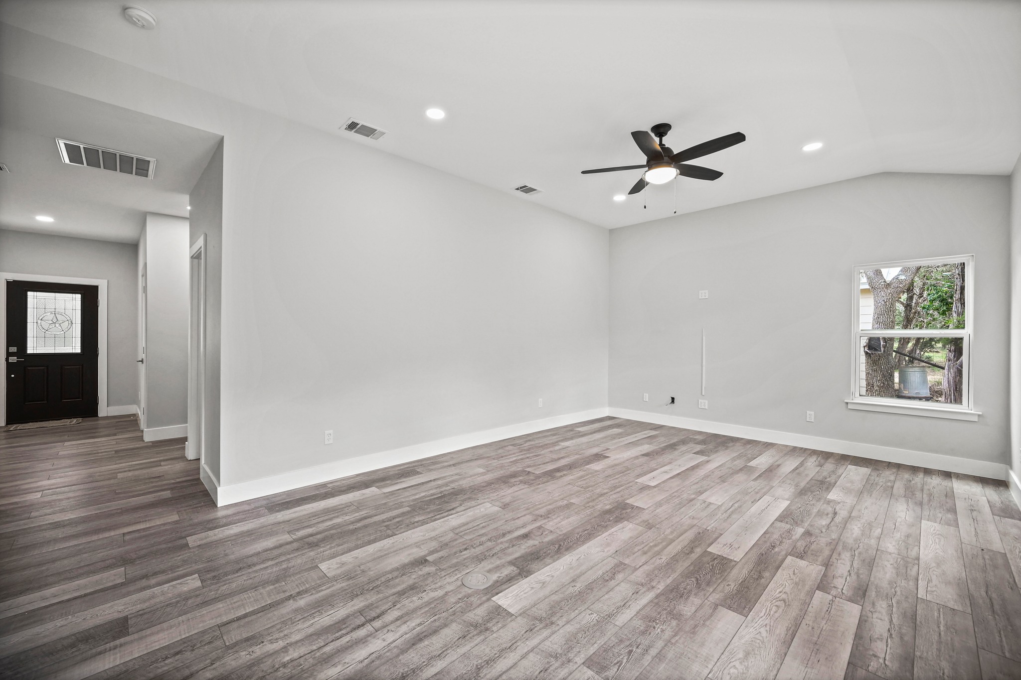 231 North Rainbow Ranch Road Wimberley, TX 78676 - Photo 13 of 40 A welcoming entryway transitions into a spacious living area featuring vaulted ceilings and abundant natural light.