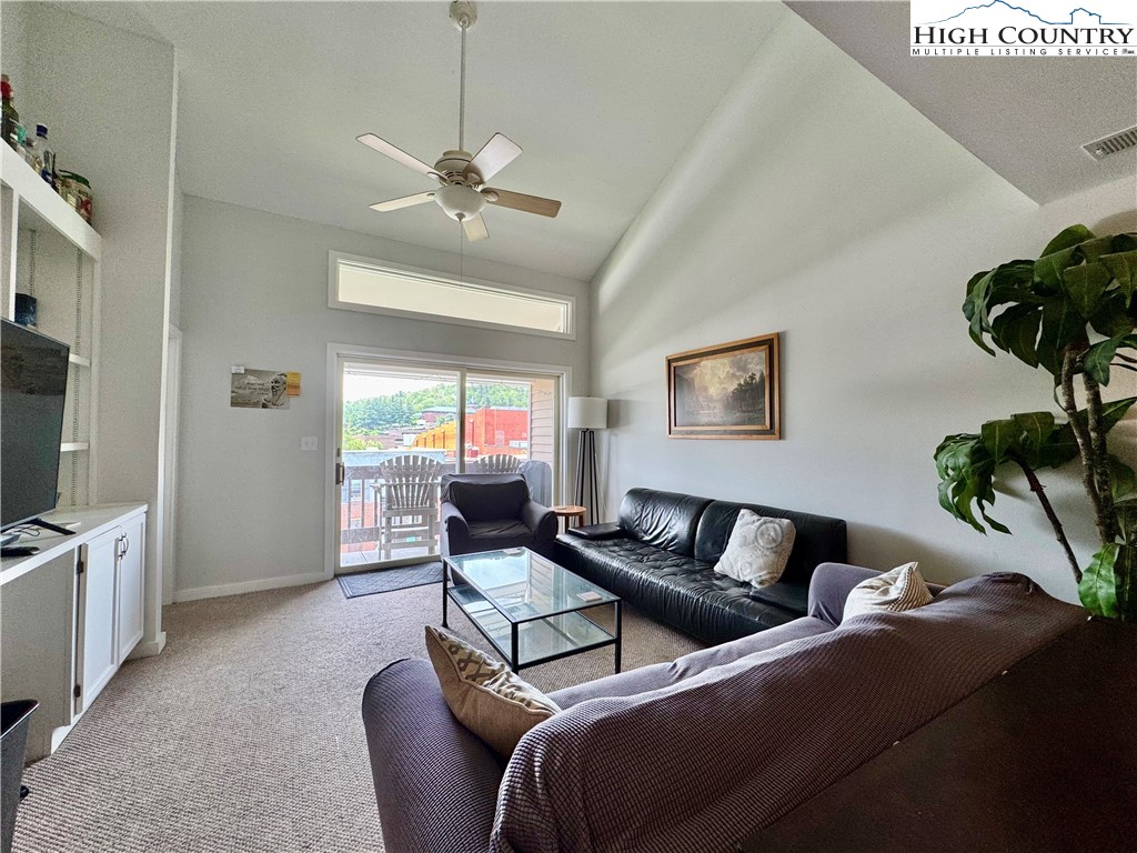 116 Grand Boulevard, Unit 4B Boone, NC 28607 - Photo 4 of 15 a living room with furniture and a flat screen tv