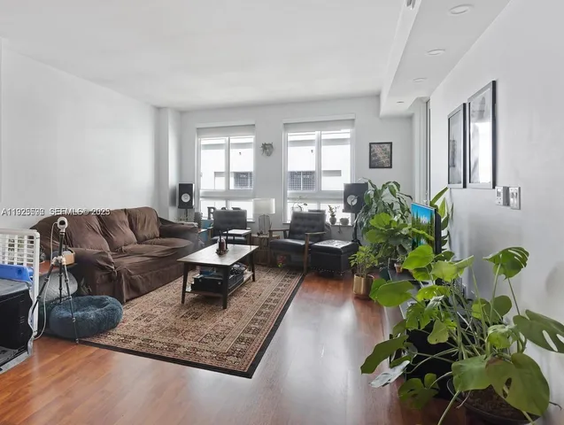 a living room with furniture potted plant and a window
