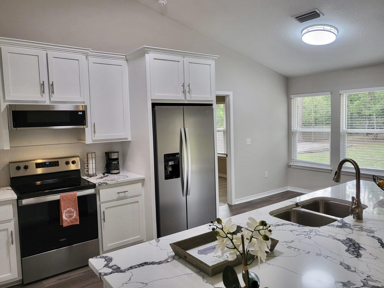 6330 Possum Ridge Road Crestview, FL 32539 - Photo 1 of 22 a kitchen with a sink stove and refrigerator