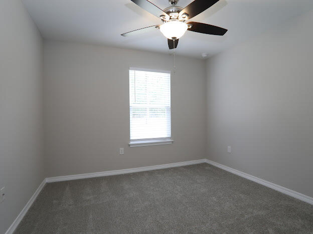 6330 Possum Ridge Road Crestview, FL 32539 - Photo 15 of 22 an empty room with a window and a fan