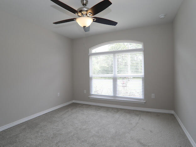 6330 Possum Ridge Road Crestview, FL 32539 - Photo 17 of 22 an empty room with a window and a fan
