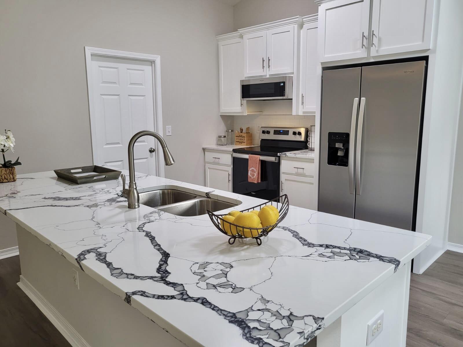 6330 Possum Ridge Road Crestview, FL 32539 - Photo 3 of 22 a kitchen with stainless steel appliances and a refrigerator