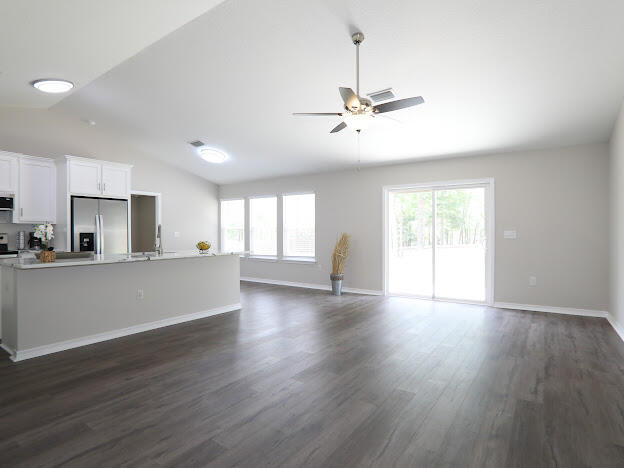 6330 Possum Ridge Road Crestview, FL 32539 - Photo 5 of 22 a view of an empty room with window and wooden floor