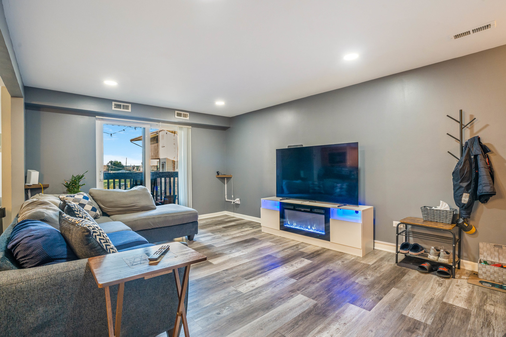 4553 West 56th Street, Unit 204 Chicago, IL 60629 - Photo 3 of 16 a living room with furniture and a flat screen tv