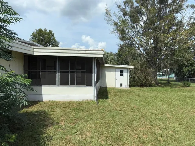 a view of a house with a backyard