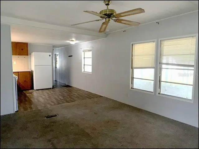 a kitchen with a refrigerator a stove top oven and cabinets