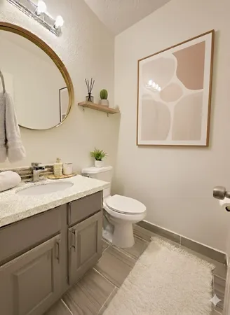 a bathroom with a toilet sink and mirror