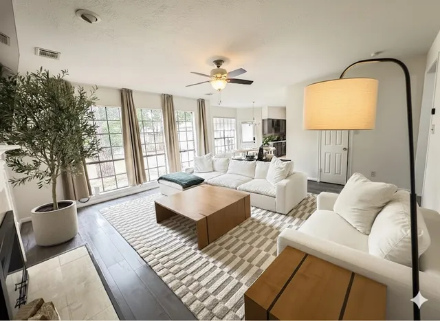a living room with furniture a chandelier and a window