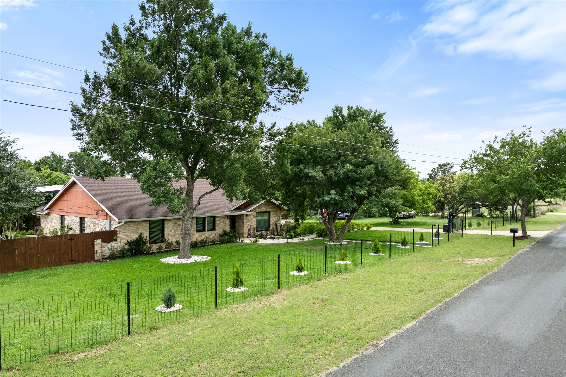 301 Oak Ridge Road Georgetown, TX 78628 - Photo 2 of 34 Brick exterior featuring a hip roof, dark window trim, and a prominent mature tree