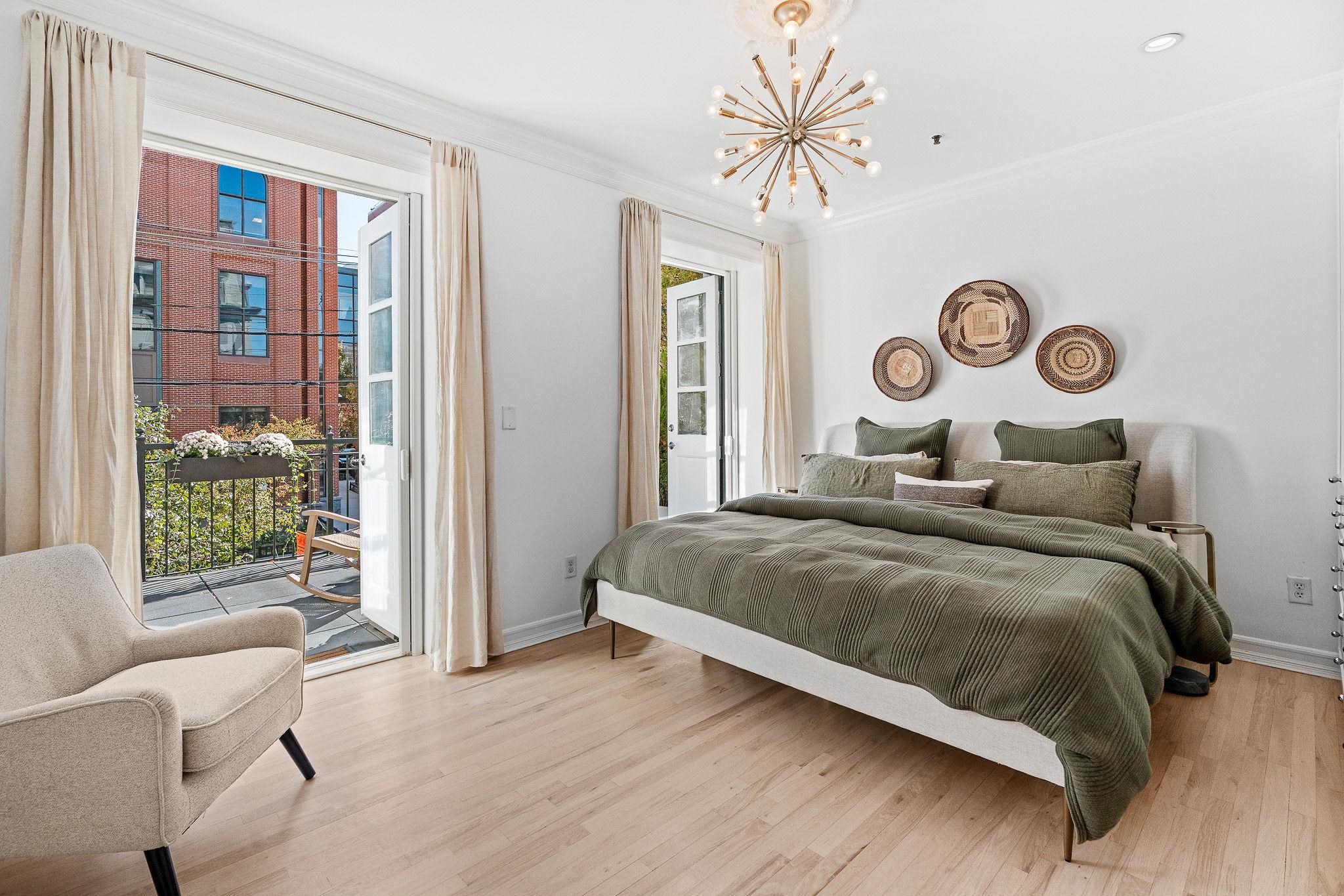 600 Hudson Street, Unit 2B Hoboken, NJ 07030 - Photo 11 of 20 a bedroom with a bed and a chandelier