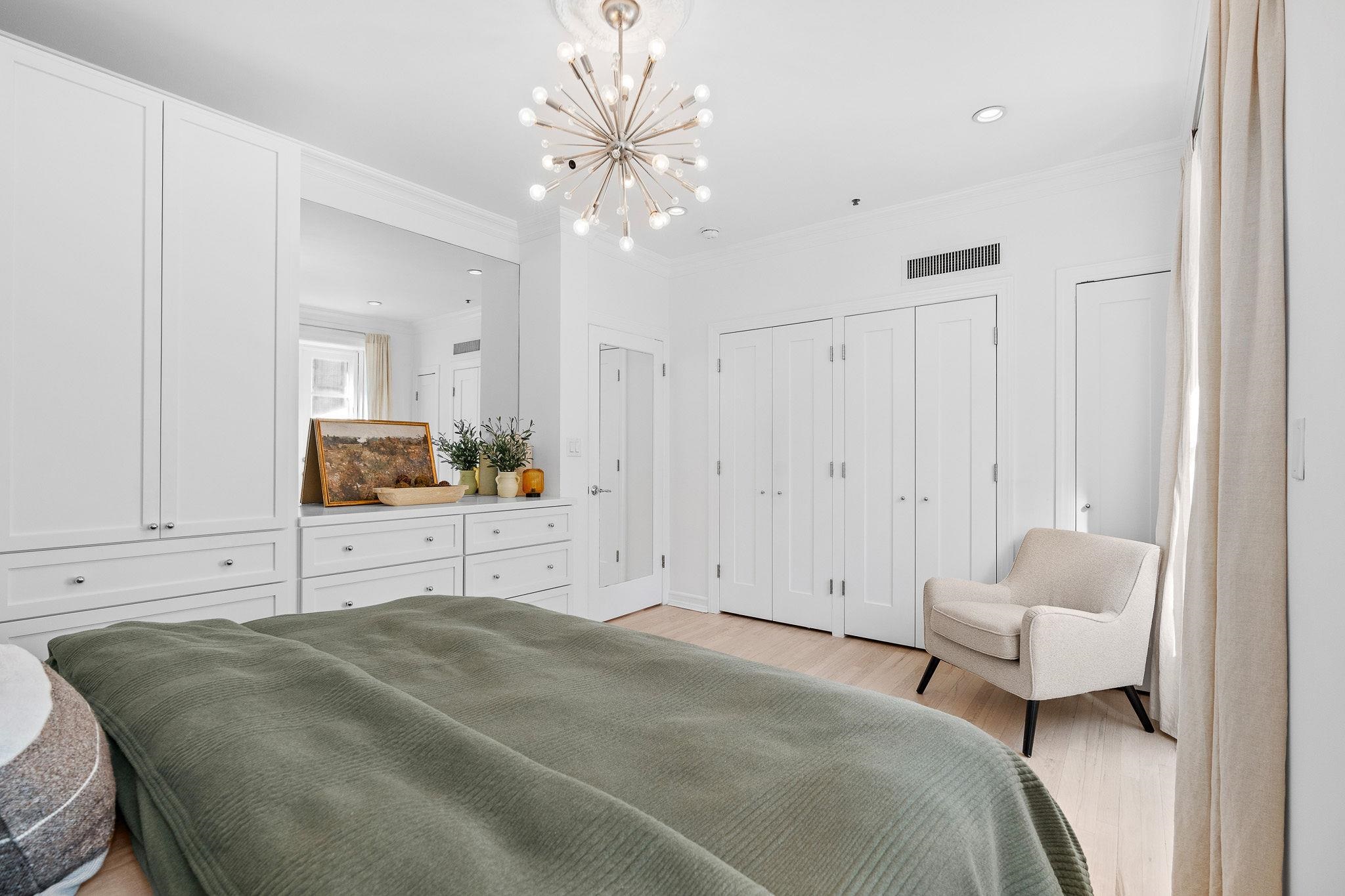 600 Hudson Street, Unit 2B Hoboken, NJ 07030 - Photo 13 of 20 a spacious bedroom with a bed a couch and dresser