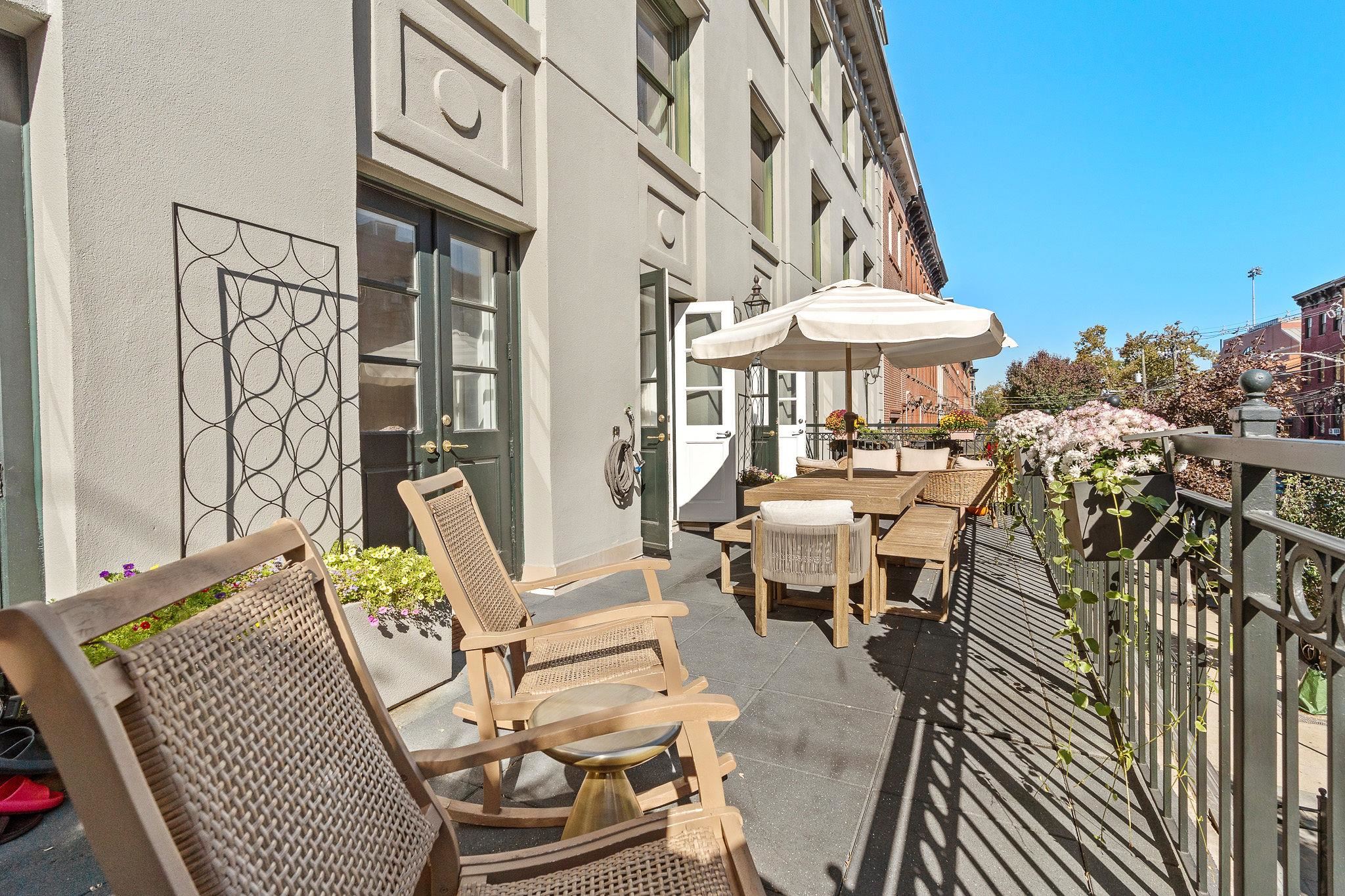 600 Hudson Street, Unit 2B Hoboken, NJ 07030 - Photo 17 of 20 a view of a patio with couches table and chairs and potted plants