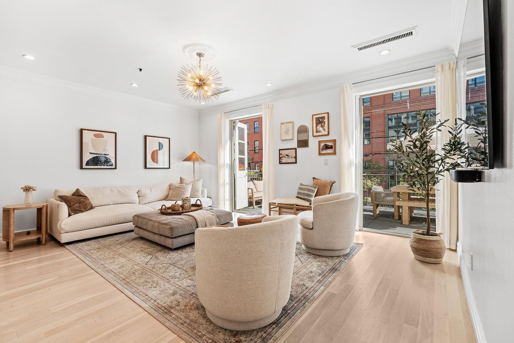 600 Hudson Street, Unit 2B Hoboken, NJ 07030 - Photo 2 of 20 a living room with furniture potted plant and a window