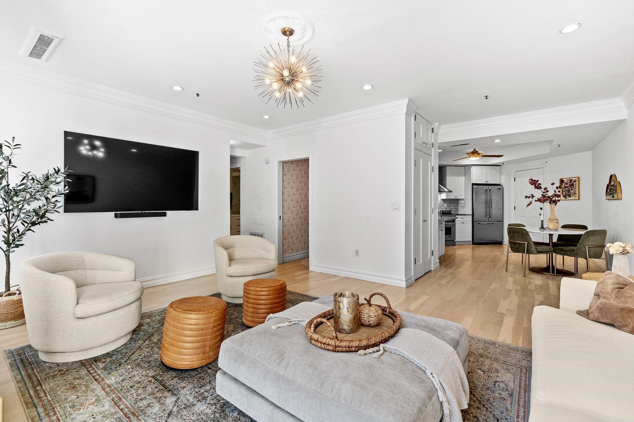 600 Hudson Street, Unit 2B Hoboken, NJ 07030 - Photo 3 of 20 a living room with furniture and a flat screen tv
