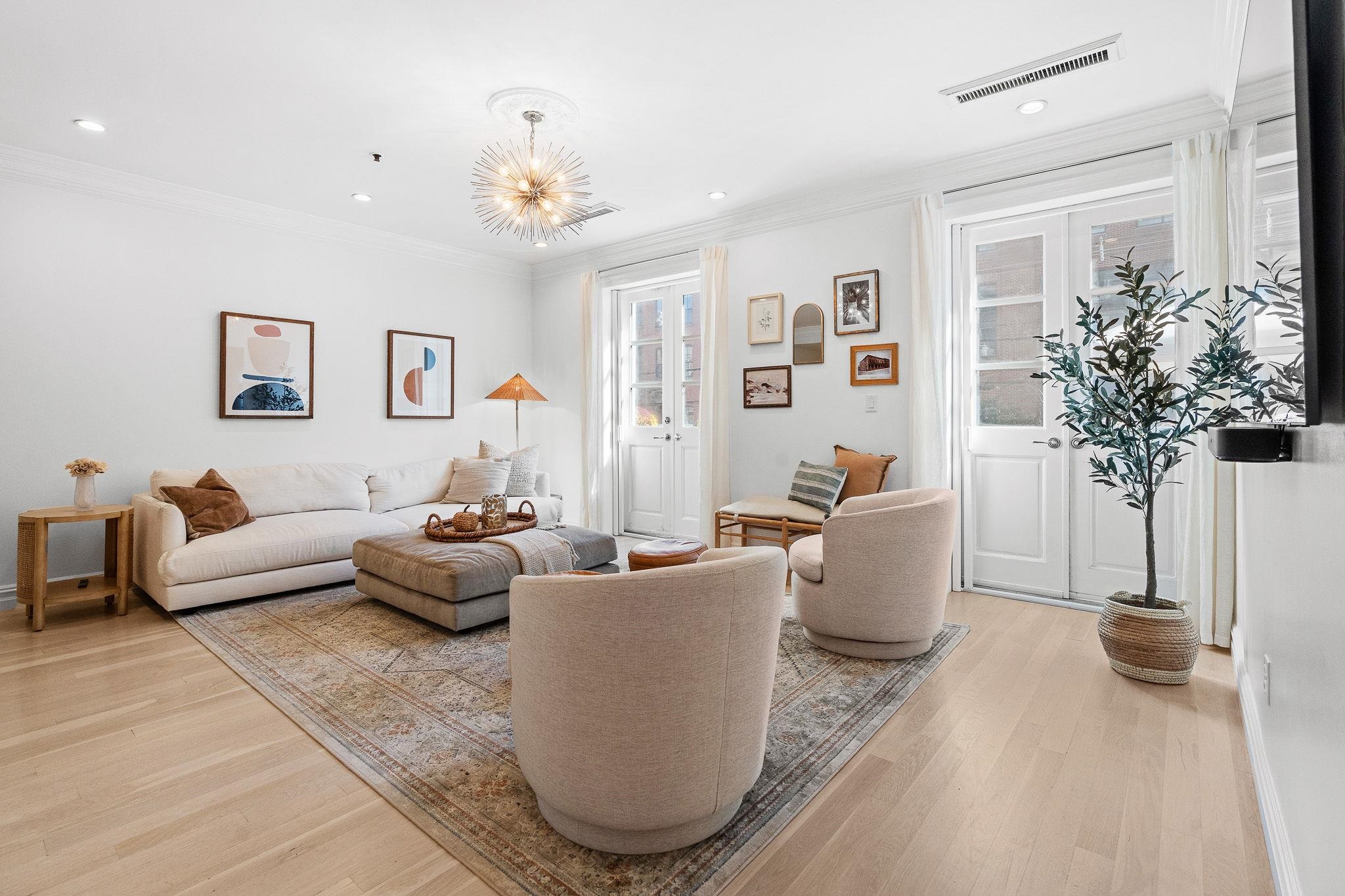 600 Hudson Street, Unit 2B Hoboken, NJ 07030 - Photo 4 of 20 a living room with furniture and a potted plant