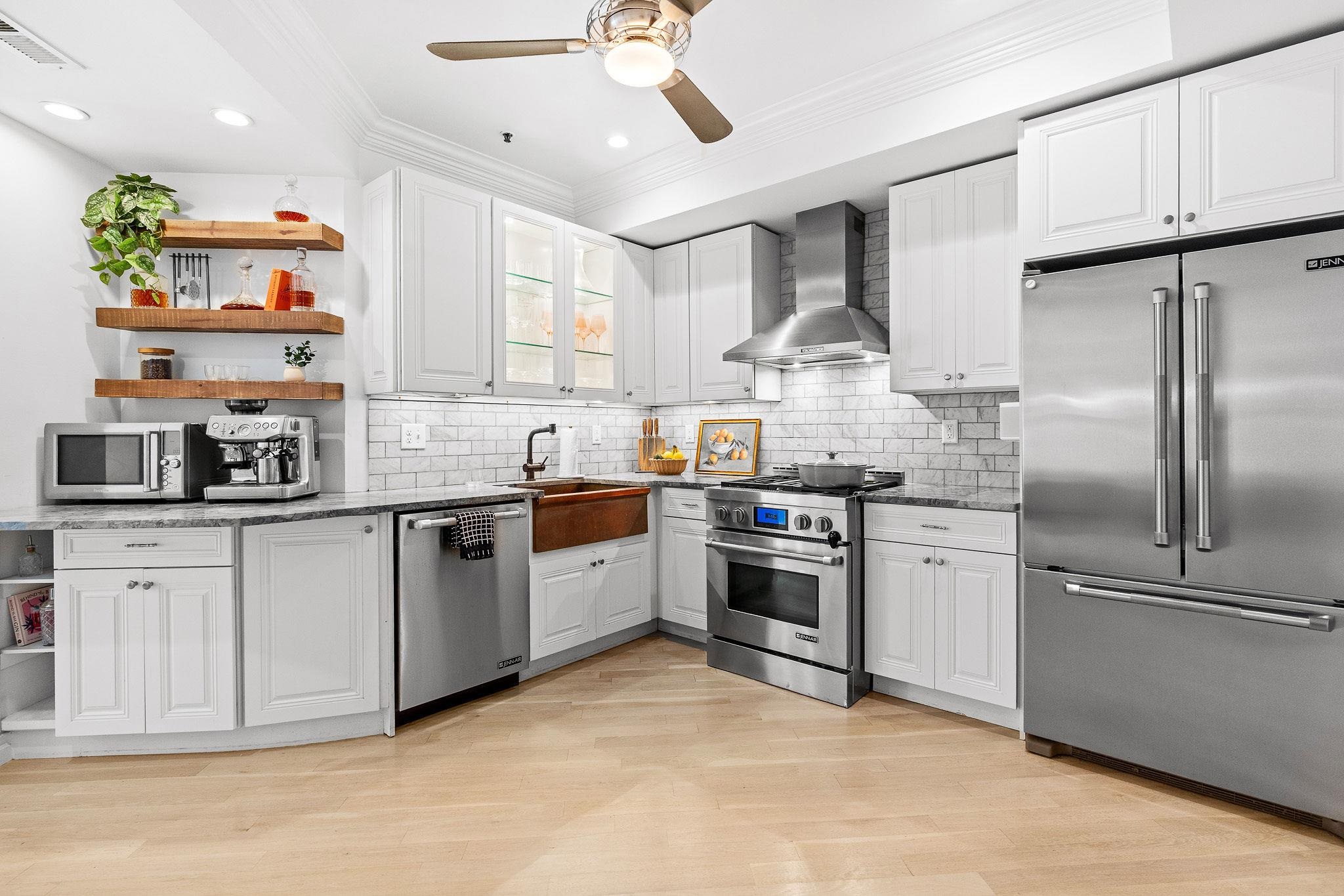 600 Hudson Street, Unit 2B Hoboken, NJ 07030 - Photo 7 of 20 a kitchen with stainless steel appliances granite countertop a refrigerator a stove and a sink with cabinets