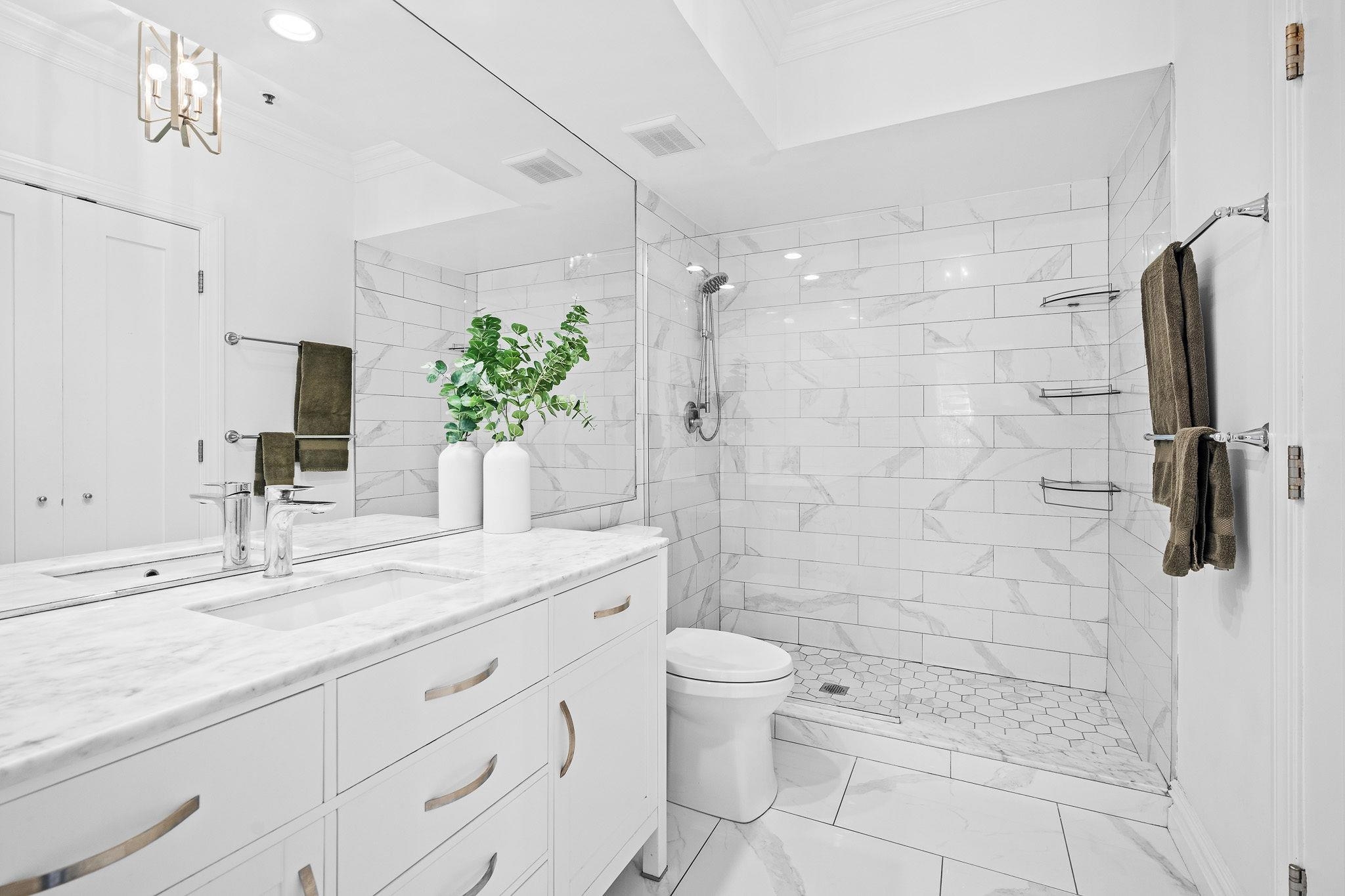 600 Hudson Street, Unit 2B Hoboken, NJ 07030 - Photo 10 of 20 a bathroom with a granite countertop sink a toilet and shower