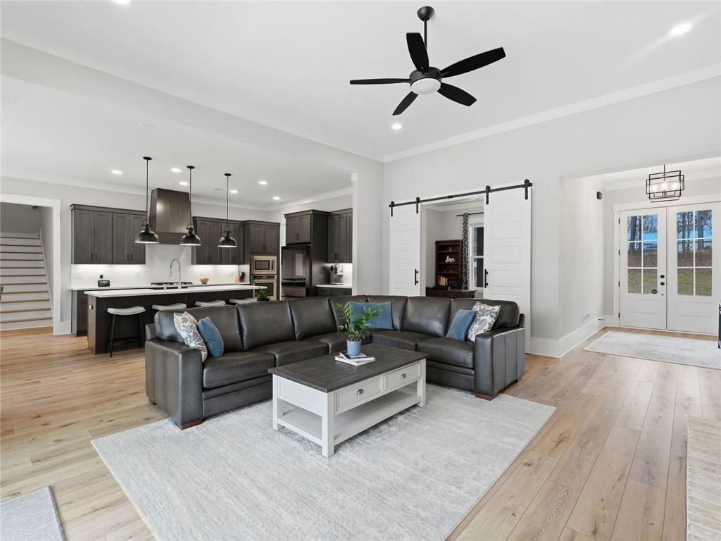 877 Arnold Mill Road Woodstock, GA 30188 - Photo 11 of 62 a living room with furniture kitchen view and a wooden floor