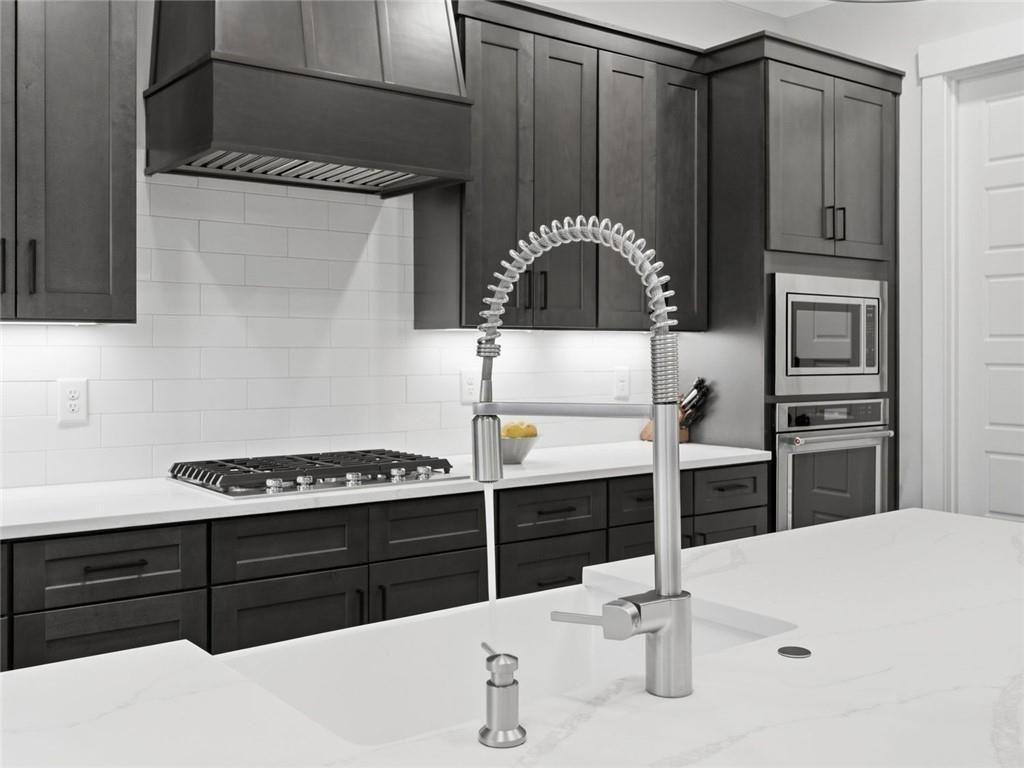 877 Arnold Mill Road Woodstock, GA 30188 - Photo 18 of 62 a kitchen with a sink a stove and cabinets