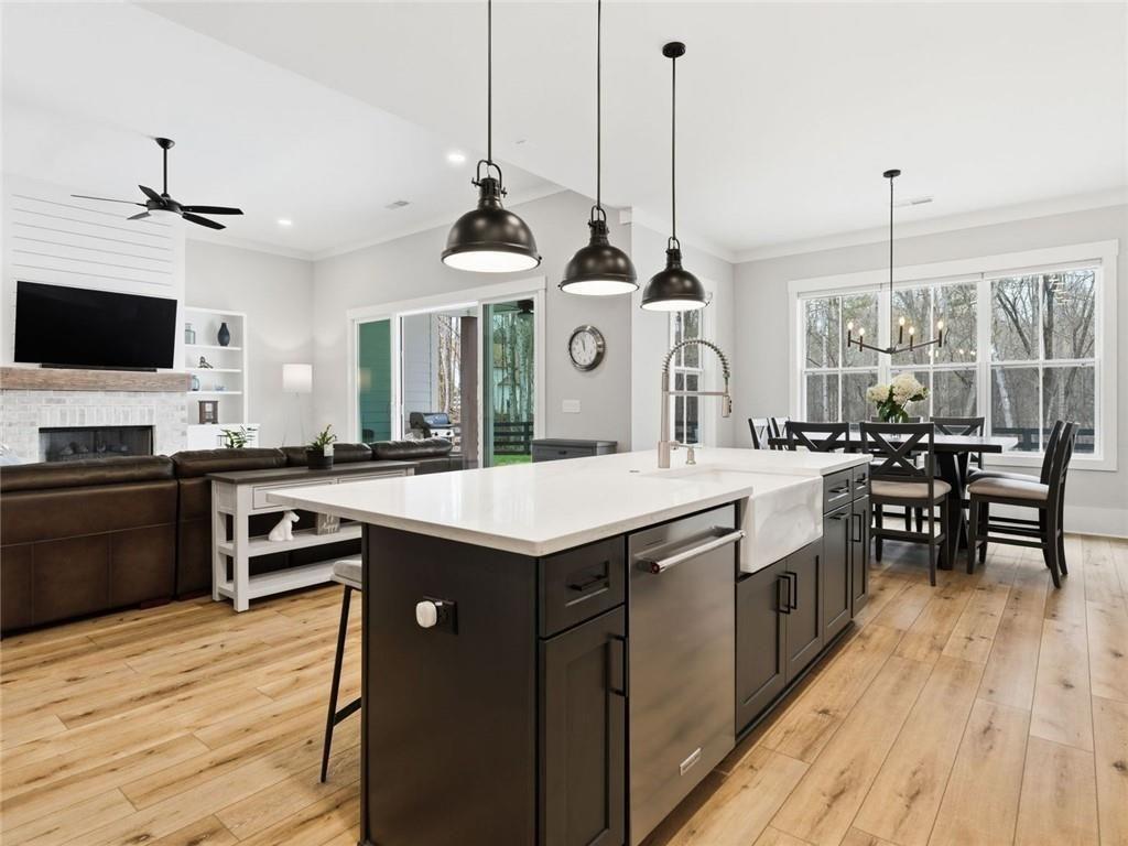 877 Arnold Mill Road Woodstock, GA 30188 - Photo 22 of 62 a kitchen with stainless steel appliances granite countertop a sink a stove and a wooden floor