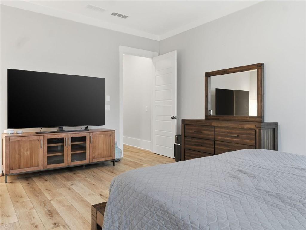 877 Arnold Mill Road Woodstock, GA 30188 - Photo 26 of 62 a bedroom with a bed and a flat screen tv