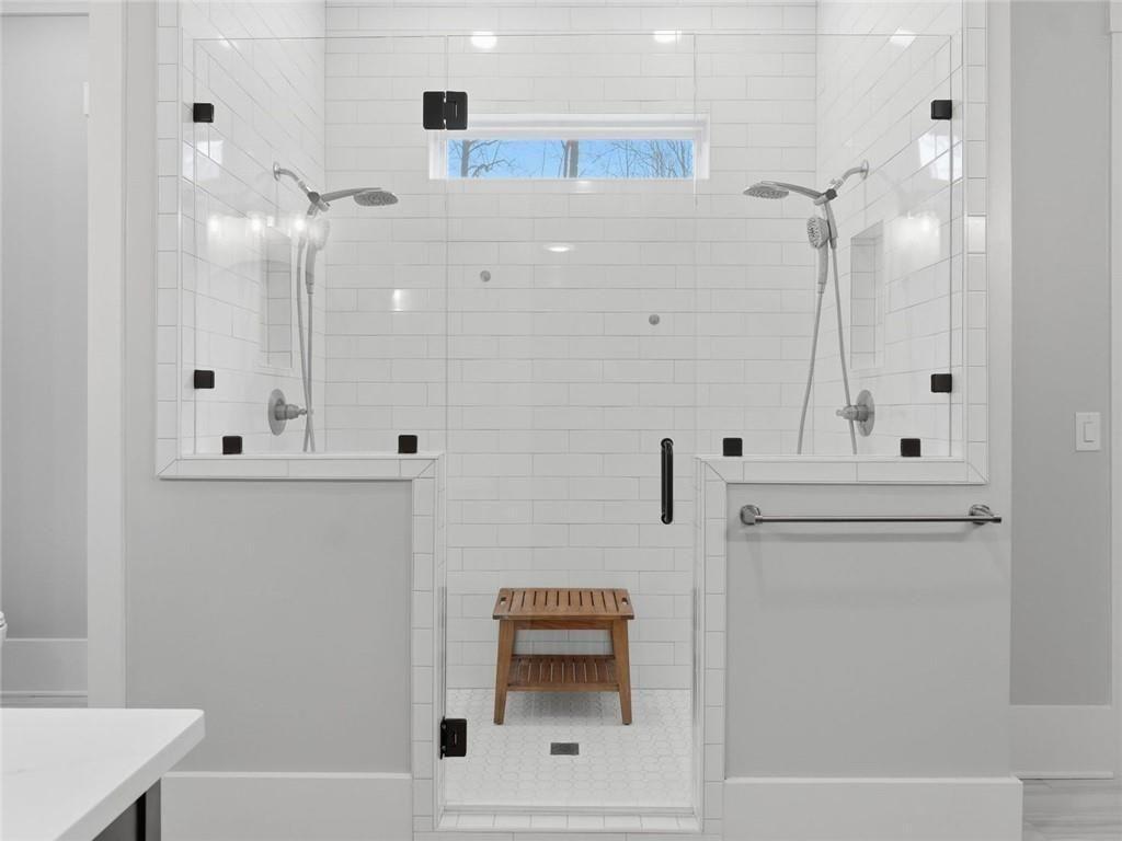 877 Arnold Mill Road Woodstock, GA 30188 - Photo 28 of 62 a bathroom with a sink a mirror and shower