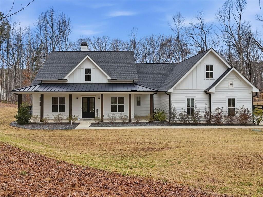 877 Arnold Mill Road Woodstock, GA 30188 - Photo 3 of 62 a front view of a house with a yard