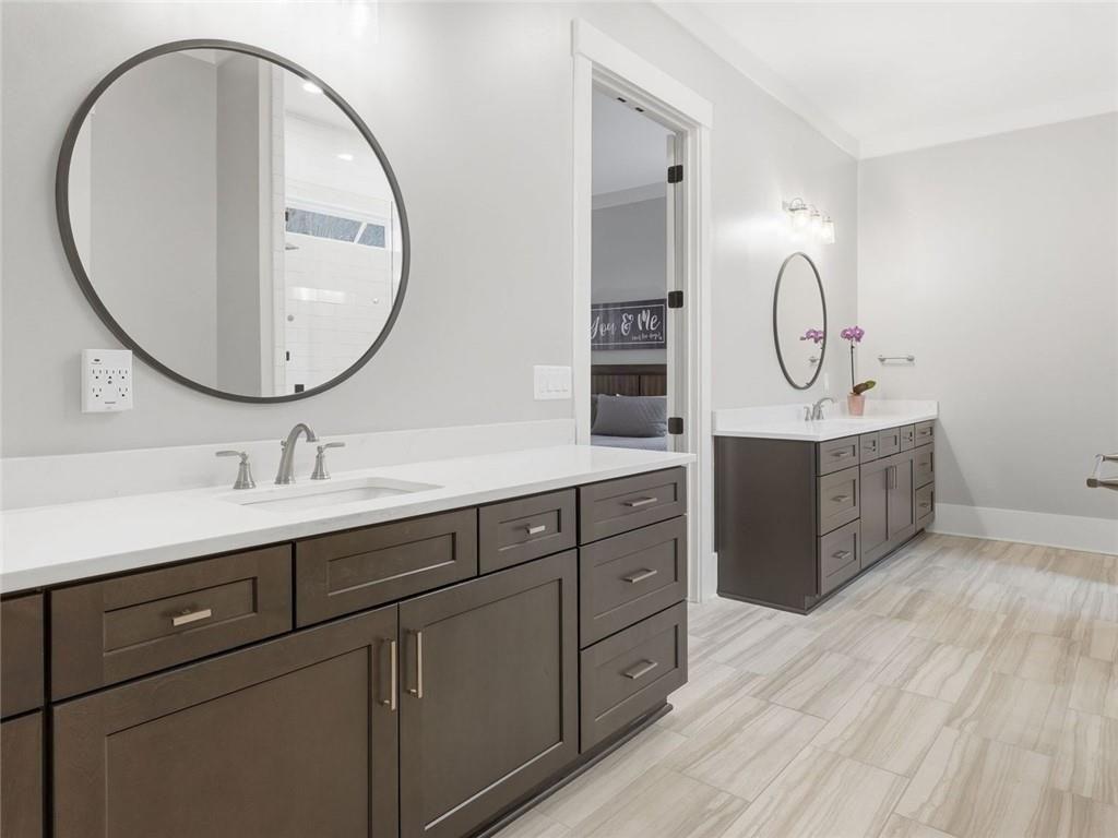 877 Arnold Mill Road Woodstock, GA 30188 - Photo 32 of 62 a bathroom with a double vanity sink and a mirror