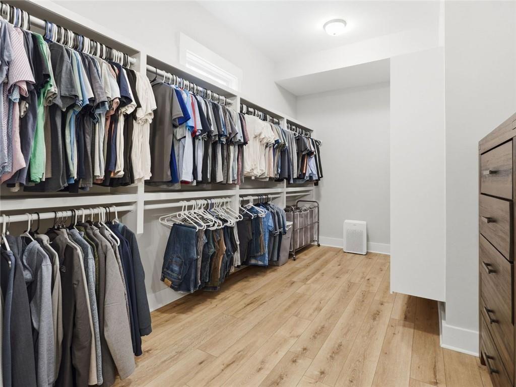 877 Arnold Mill Road Woodstock, GA 30188 - Photo 33 of 62 a view of walk in closet with clothes and shoes