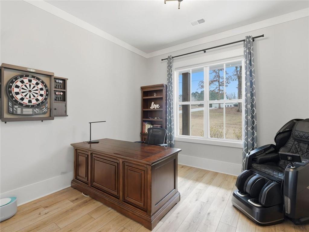 877 Arnold Mill Road Woodstock, GA 30188 - Photo 35 of 62 a room with furniture and wooden floor