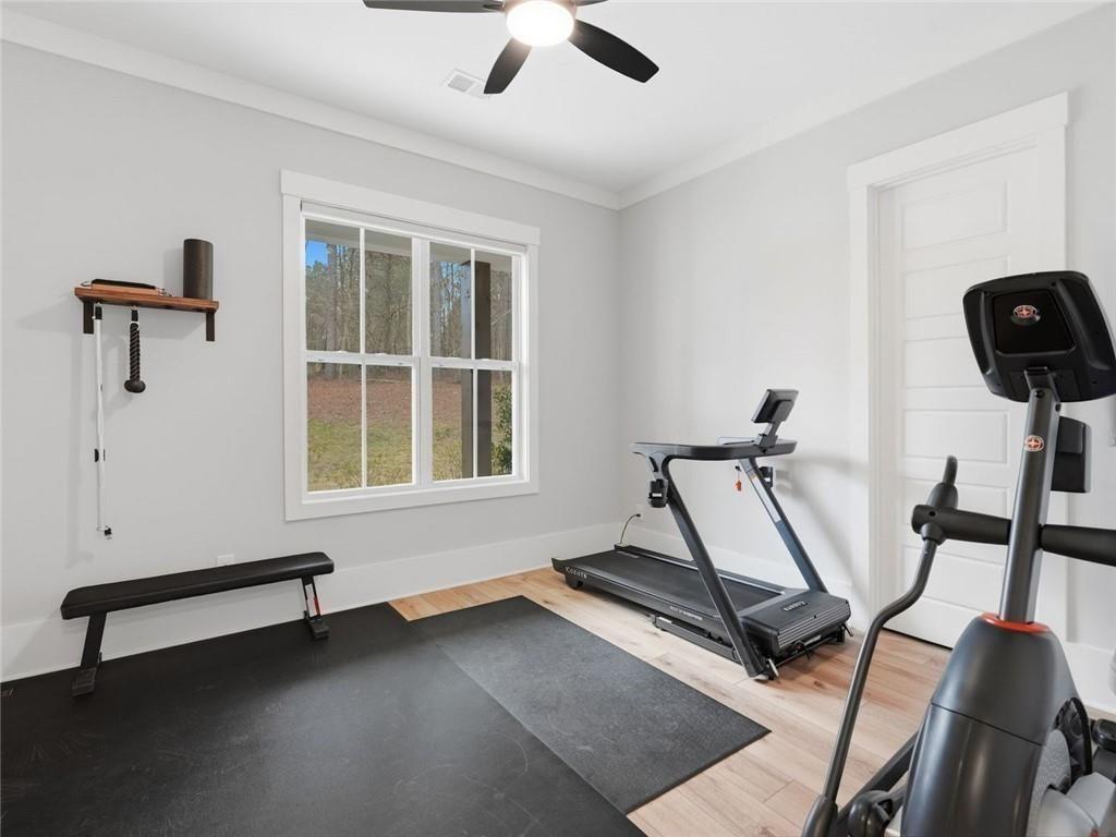 877 Arnold Mill Road Woodstock, GA 30188 - Photo 36 of 62 a room with gym equipment and windows