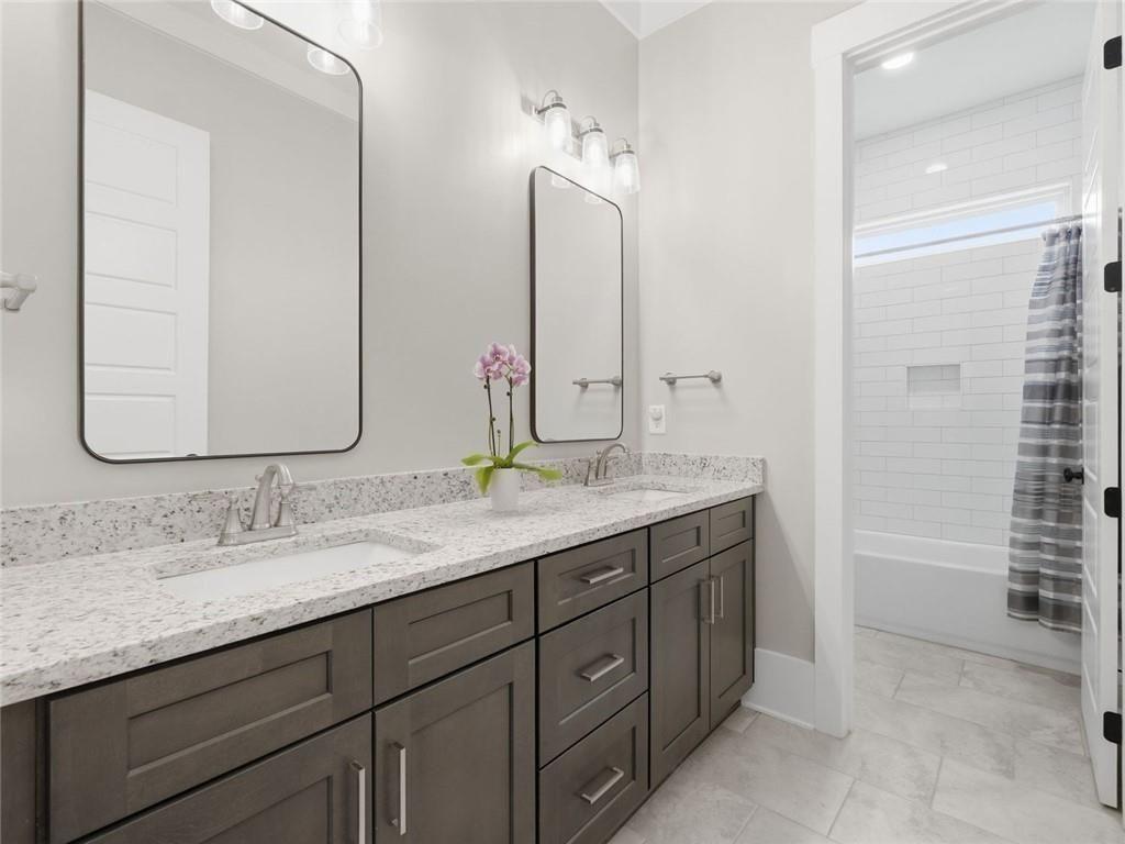 877 Arnold Mill Road Woodstock, GA 30188 - Photo 37 of 62 a bathroom with a double vanity sink and a mirror