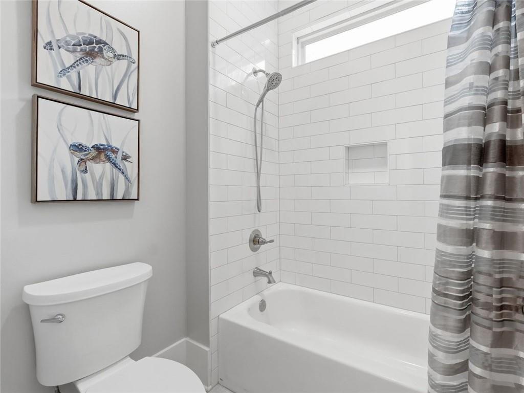 877 Arnold Mill Road Woodstock, GA 30188 - Photo 38 of 62 a bathroom with a toilet and a shower