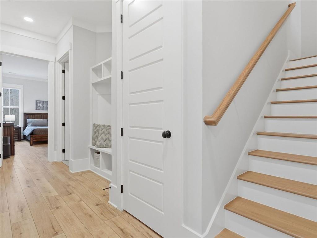 877 Arnold Mill Road Woodstock, GA 30188 - Photo 43 of 62 a view of a hallway with wooden floor and staircase