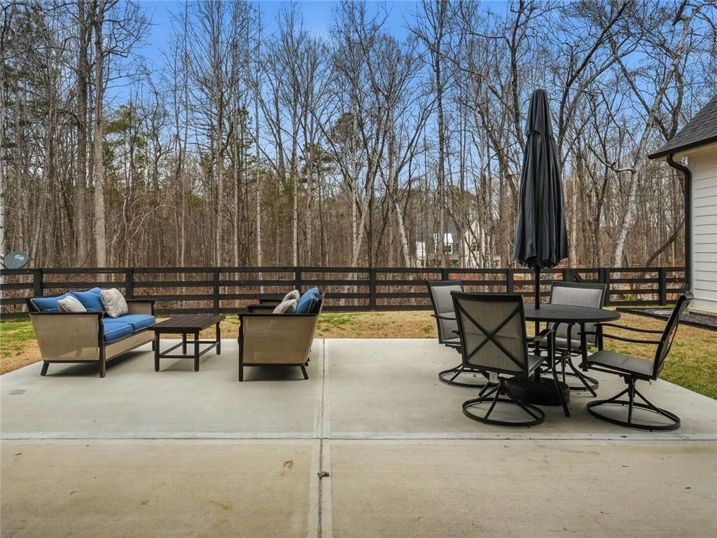 877 Arnold Mill Road Woodstock, GA 30188 - Photo 50 of 62 a view of a terrace with furniture and trees