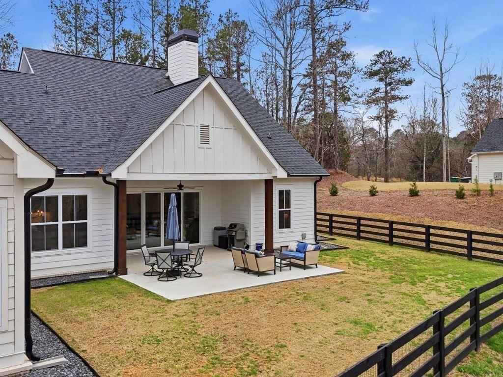 877 Arnold Mill Road Woodstock, GA 30188 - Photo 51 of 62 a view of a house with backyard and sitting area