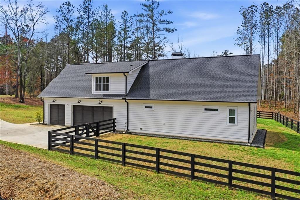 877 Arnold Mill Road Woodstock, GA 30188 - Photo 53 of 62 a view of a house with pool and chairs